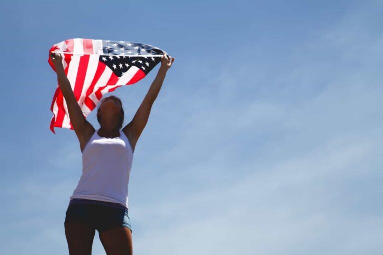 woman holding us flag during daytime