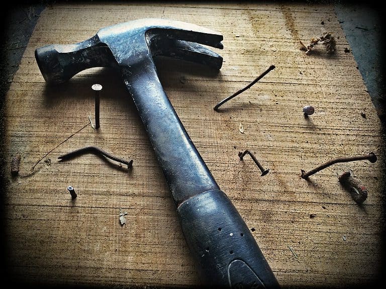 black claw hammer on brown wooden plank